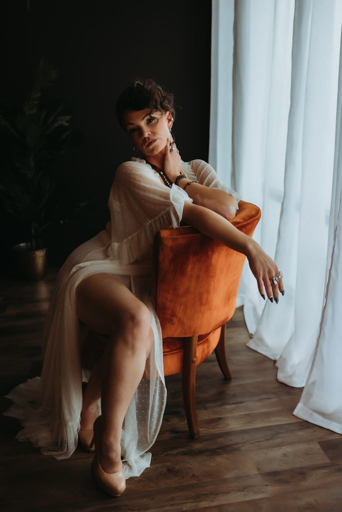 portland boudoir studio woman sitting on chair posing for portland boudoir photographer