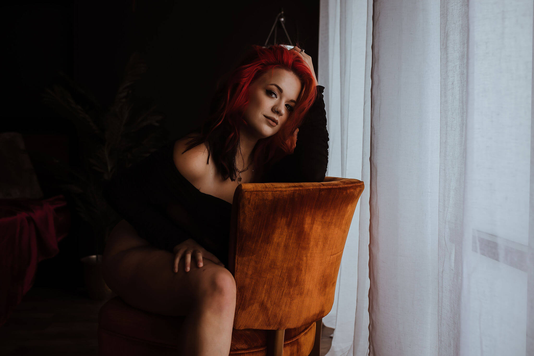Woman sitting on chair posing for boudoir shoot at Sommer Fine Art Studio